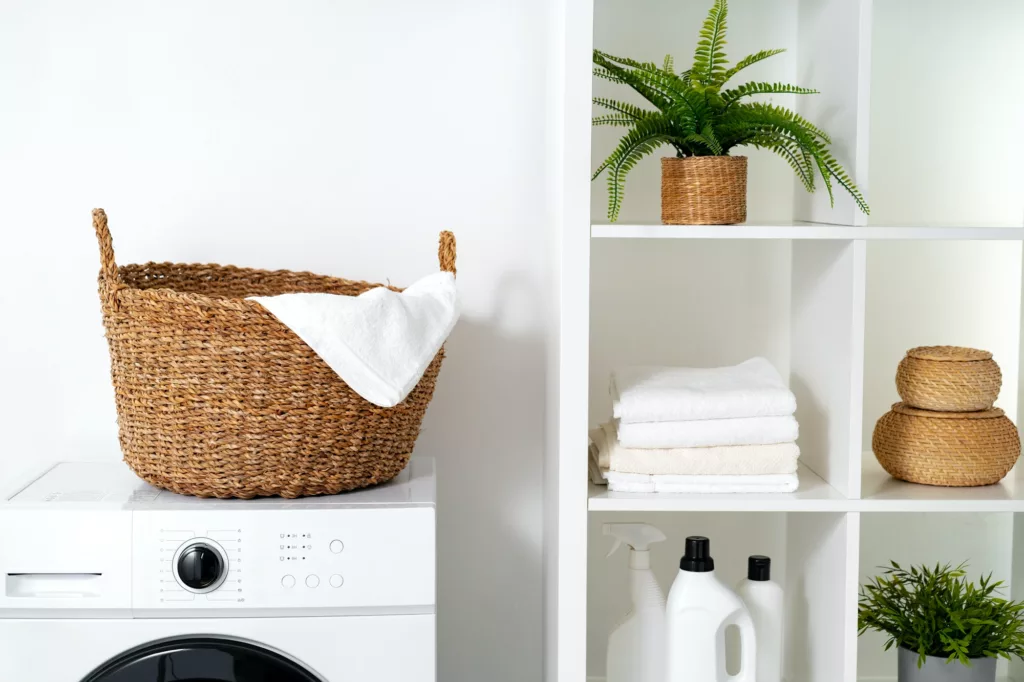 Laundry room with washing machine and basket with laundry